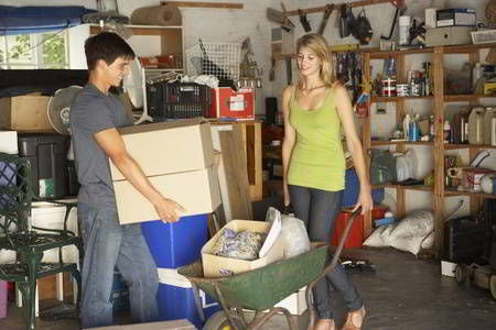 Two teenagers clearing garage for yard sale