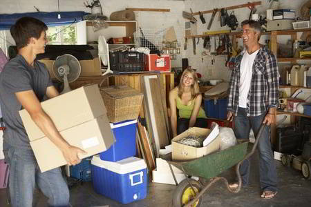 family clearing garage from household junk